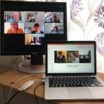 A laptop and monitor showing an online training course in progress