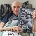 ‘Red Ronnie’ Campbell holding a copy of Robert’s book, Backbone of the Nation.
