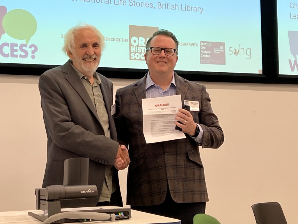 John Gabriel, OHS Chair, presenting the statement of support to Steven Sielaff, Associate Director of the US Oral History Association at the OHS annual conference.