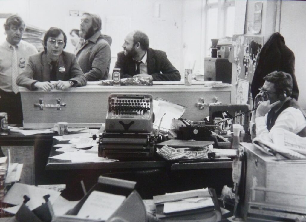Journalists gathered around the ceremonial coffin on the last day of the Sheffield Morning Telegraph, February 1986 Photographer: Stephen McClarence